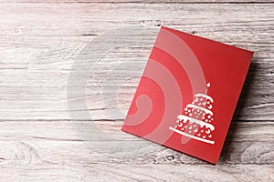 Red greeting card on a light wooden background