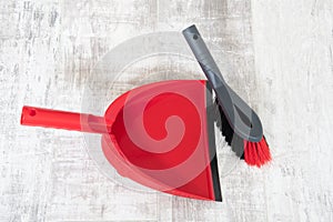 Red and grey dustpan and brush
