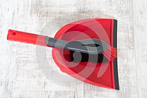 Red and grey dustpan and brush
