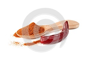 Red ground paprika powdered or dry chili pepper with wooden spoon isolated on white background