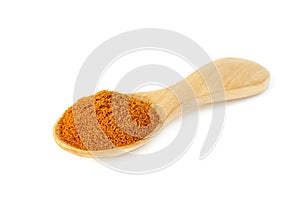 Red ground paprika powdered or dry chili pepper with wooden spoon isolated on white background