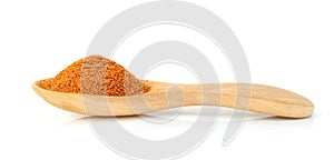 Red ground paprika powdered or dry chili pepper with wooden spoon isolated on white background