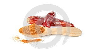 Red ground paprika powdered or dry chili pepper with wooden spoon isolated on white background