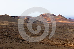 Red ground volcanos in Timanfaya National Park