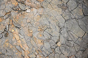 Red grunge background. Rock texture with cracks. Red brown yellow mountain texture closeup. Cracked stone surface. Natural stone