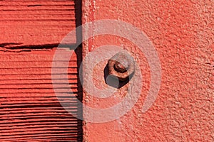 Red grunge nut and bolt with focus only on one nut