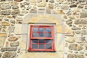 Red guillotine window on a stone framed window