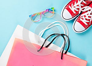Red gumshoes with shpping bags and glasses photo