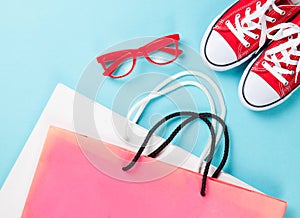 Red gumshoes with shpping bags and glasses photo