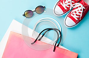Red gumshoes with shpping bags and sunglasses photo
