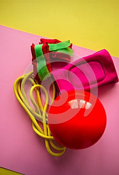 Red gymnastic ball, kneepads, weightings and skipping rope on a