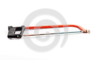 Red hacksaw on a white background in studio