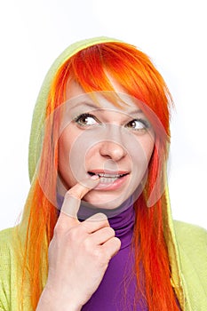 Red hair curious woman with finger at mouth