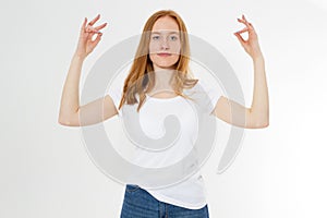 Red hair teen lady in zen pose poratrait on light background, practicing yoga and meditation, holding palms together in zen mudra