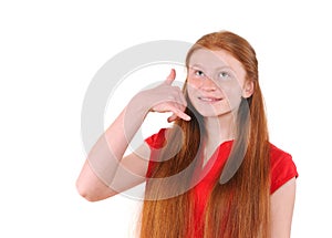 Red hair teenager girl in a red shirt showing a call me sign