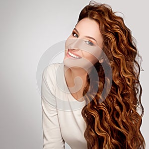 Red Hair. Woman with Beautiful Curly Hair