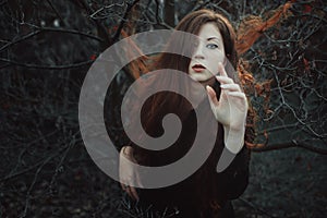 Red hair woman in desolate forest