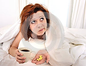 Red hair woman with hangover taking coffee