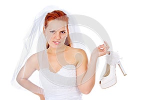 The red-haired bride keep a wedding shoes