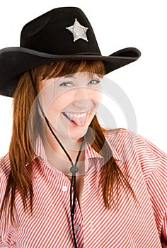 Red haired cowgirl in hat grimacing