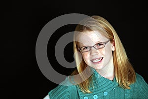 Red haired girl with braces and glasses