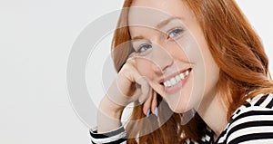 Red haired girl with close up macro face and perfect white teeth smile  on white background. Woman beauty and skin care.