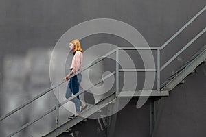 Red-haired girl down the stairs
