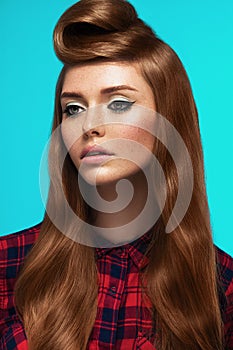 Red-haired girl, freckled face, trendy makeup and hairstyle