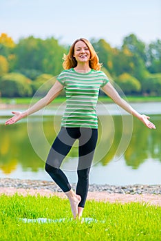 Red-haired girl laughs and perform exercises