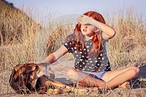 Red haired girl with pet dog