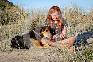 Red haired girl with pet dog