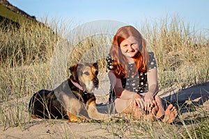 Red haired girl with pet dog