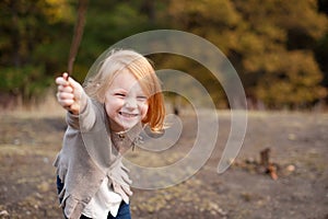 Red-haired girl is playing and laughing