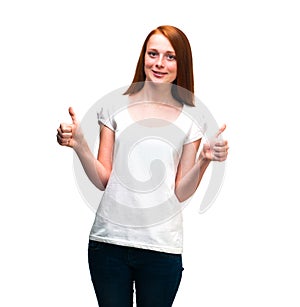 Red-haired girl showing thumbs up. Isolated on white background