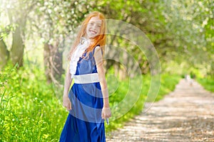 Red-haired girl in a sunny garden