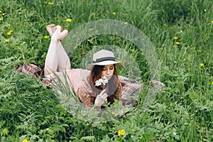 Red-haired girl walks in a spring blooming apple orchard