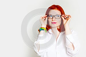 Red-haired girl in a white blouse and black glasses. Colorful an