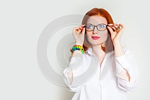 Red-haired girl in a white blouse and black glasses. Colorful an