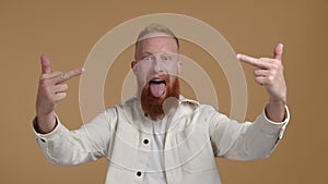 Red-haired man showing obscene gestures and his tongue