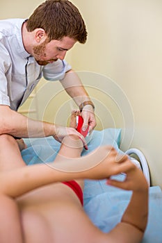 red-haired physician puts fixing tape on the child photo