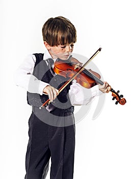 Red-haired preschooler boy with violin