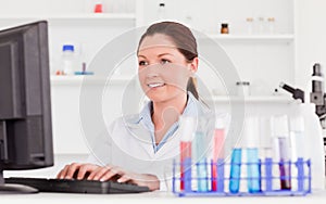 Red-haired scientist typing a report