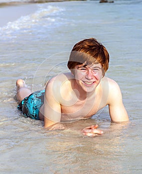 Red-haired teen boy at the beach