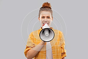 Red haired teenage girl speaking to megaphone