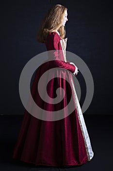 Red-haired Tudor woman in red dress