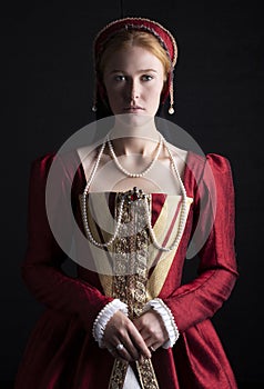 Red-haired Tudor woman in red dress