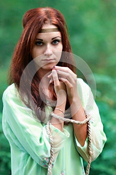 Red-haired upset, unhappy girl with blue eyes with connected hands