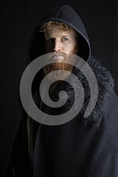 Red-haired Viking posing with weapons