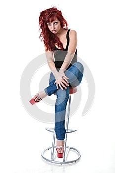 Red-haired woman in black corset and blue jeans