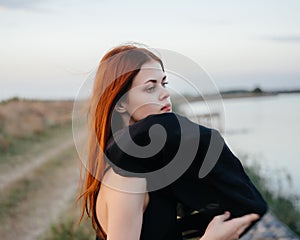 Red-haired woman black veil nature posing